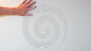 Footage a female hand moving, making deleting or painting gesture sign or symbol on plain background, with copy space for