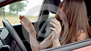 Footage of frustrated young woman shouting and getting mad while driving a car