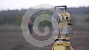Footage of the geodesy equipment and a worker in the background