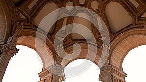 footage of the Palace of Fine Arts with tall stone pillars, statues and lush green trees, grass and plants and blue sky