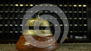 Footage of a person ringing on a bell at a hotel reception