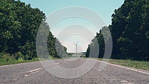 Footage of road and eolian wind turbine