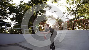 Footage of skater wearing inline roller blades for extreme skating in outdoor modern skatepark. Popular action sport for