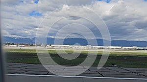 footage of the tarmac at the Ontario International Airport with planes and runways, blue sky and clouds in Ontario