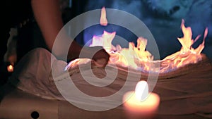 Footage of woman wrapped in a burning towel relaxing in spa salon. Chinese fire massage