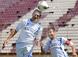 Footbal players hits the ball with the head