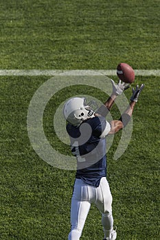Football action photo of athlete catching a touchdown pass