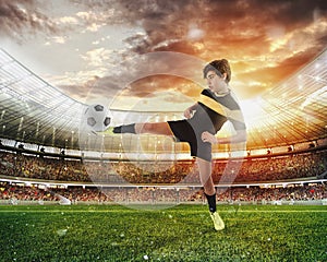 Football scene with competing young football players at the stadium