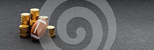 Football Ball ahead of Stacks of Coins on Dark Background