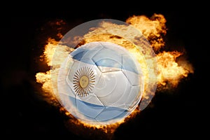 Football ball with the flag of argentina on fire