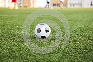 Football ball on fresh spring green grass
