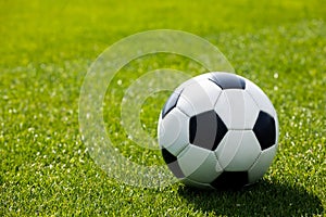 Football Ball on a Grass Field. Green Grass Soccer Pitch