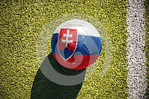 Futbalová lopta so štátnou vlajkou slovenska leží na ihrisku