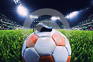 Football ball with whistle on the grass on soccer stadium, vintage effect