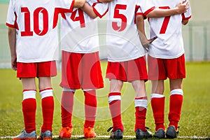 Football children team. Kids soccer substitute players standing together on a row photo