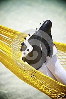 Football Cleats Soccer Player Relaxing in Beach Hammock