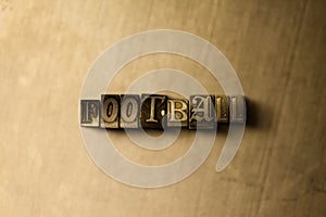 FOOTBALL - close-up of grungy vintage typeset word on metal backdrop