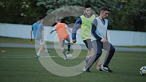 Football club training. A close-up of the player`s legs jumping over the barrier and running across the field. Slow