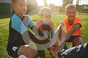 Football coach motivating junior football team before match