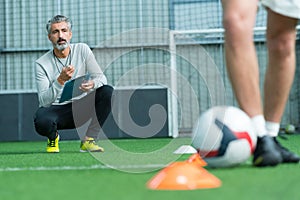 football coach watching young man training