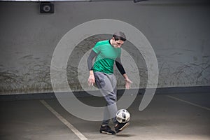 Football concept. Soccer player balancing a ball on his feet