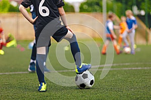 Football Education for Youths. Young Footballer Running Ball
