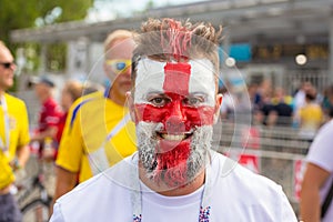 Football English fan with a painted English flag on his face at the World Cup