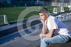 Football fan bored while sitting on stadium bleachers