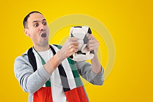 football fan with a deformed crumpled ball and with the flag of the UAE