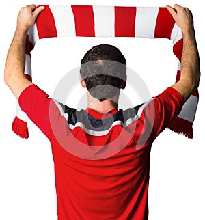 Football fan in red holding scarf