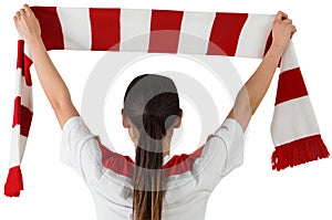 Football fan waving red and white scarf