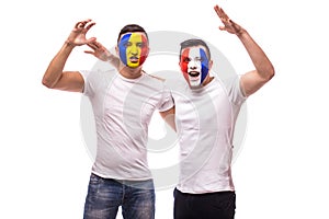 Football fans of France and Romania national teams friendly suport together the game scream at their teams at open match