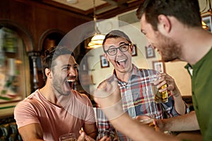 Football fans or friends with beer at sport bar