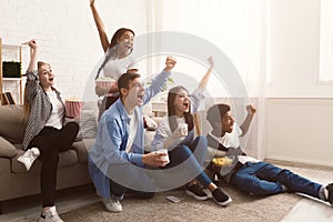 Football fans. Jouful friends screaming, watching match together