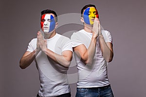 . Football fans of Romania and France national teams pray.football fans concept.