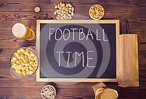 Football fans setting of beer bottle in brown paper bag, glass,