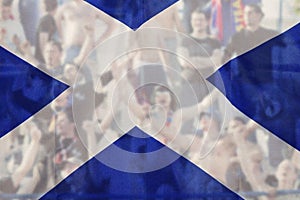 football fans supporting Scotland - crowd celebrating in stadium with raised hands against Scotland flag