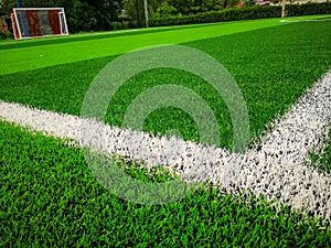Football field, astro turf surface. Close up of throw in, kick off and corner area. Lushed green football pitch