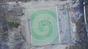 Football field from bird`s eye view. Soccer match, aerial view. Top down view of soccer field and teams playing. Sports concept