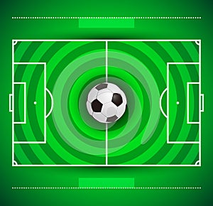 Football field with circular grass texture and soccer ball