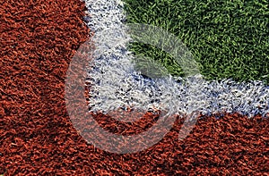 Football field,green and red soccer field in sunny day.