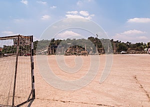 Football field and parking in close proximity to the ruins of an