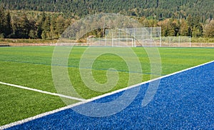 Football Field. Photo of a green synthetic grass sports field with white line