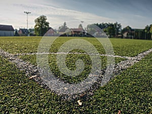 Football field whitr corner. Close up corner of white line paint on green synthetic lawn football,soccer field