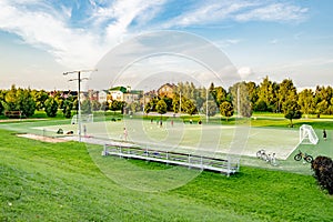 Football fields with stands for spectators in a summer park on a clear sunny day