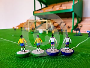 Football figures lined up on a grass field