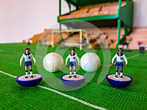 Football figures lined up on a grass field