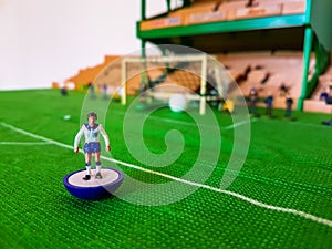 Football figures lined up on a grass field