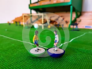 Football figures lined up on a grass field