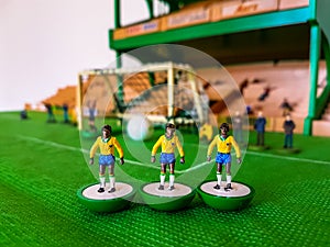 Football figures lined up on a grass field